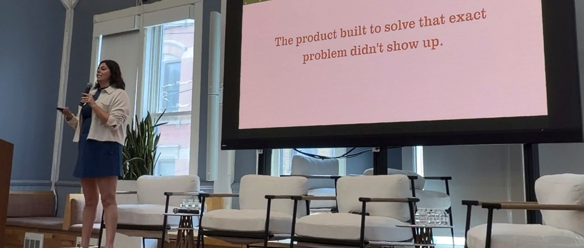 Laura Seelinger speaking at AI Week beside a slide reading: The product built to solve that exact problem didn't show up.